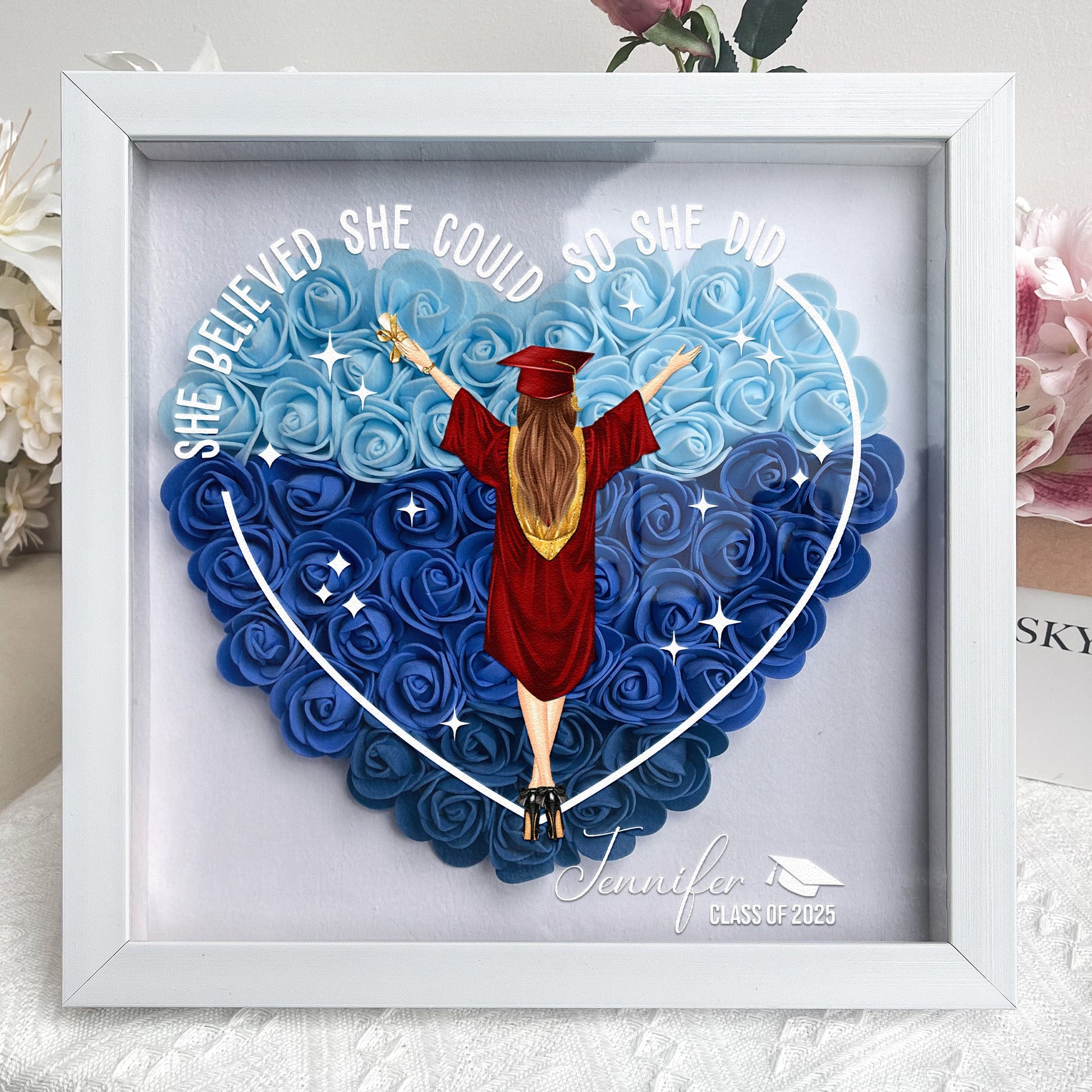 Graduation Flower Shadow Box: heart-shaped flowers, 'She believed she could so she did' message. MDF frame, acrylic front.