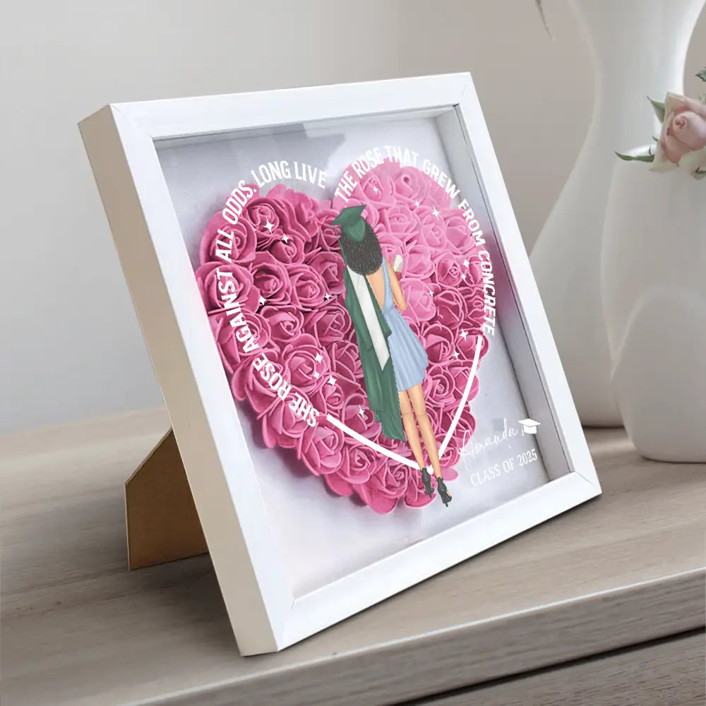 She Rose Against All Odds flower shadow box with heart-shaped pink flowers and wooden frame.