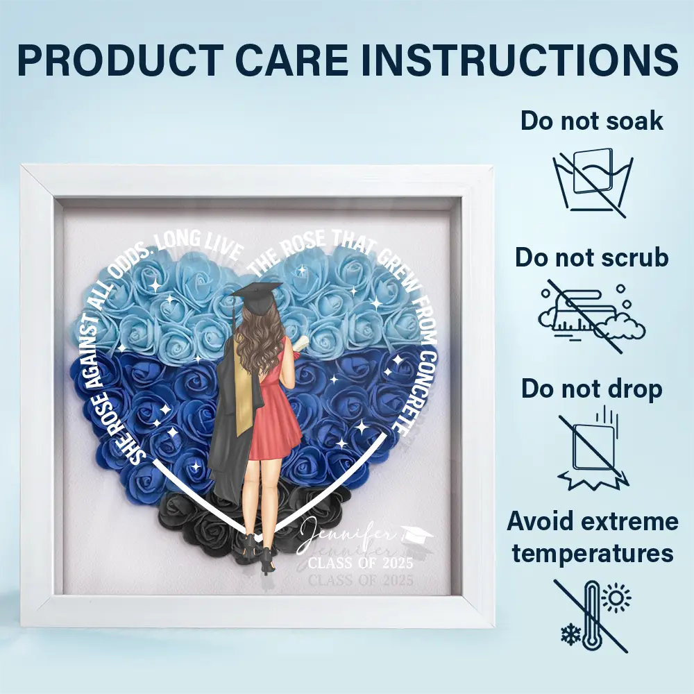 She Rose Against All Odds shadow box, graduation design, care instructions, white frame, blue flowers.